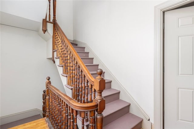 staircase featuring wood finished floors