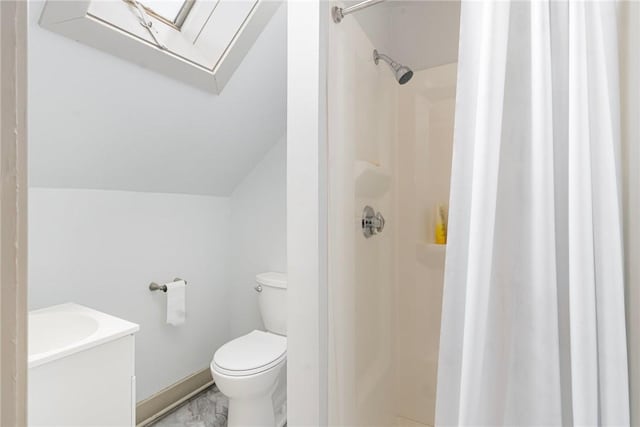 bathroom featuring lofted ceiling, toilet, vanity, marble finish floor, and a shower stall