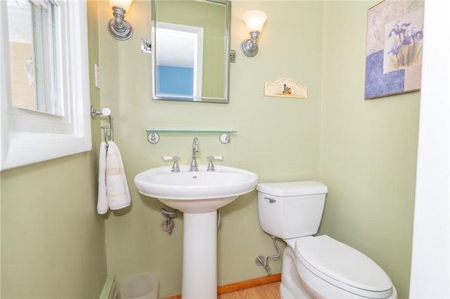 half bathroom with a sink and toilet