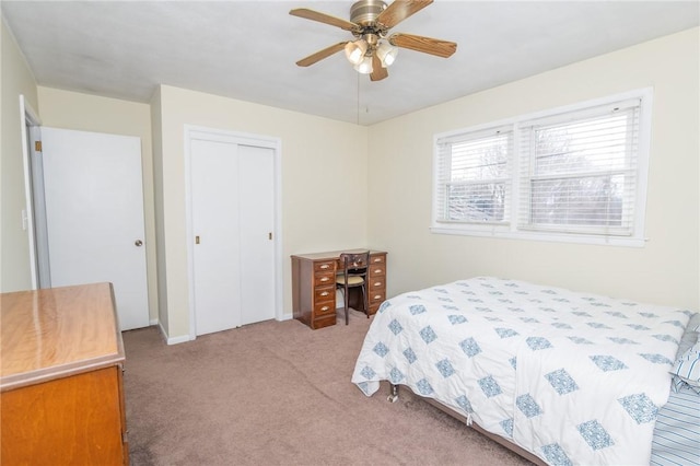 bedroom with ceiling fan, a closet, and light colored carpet