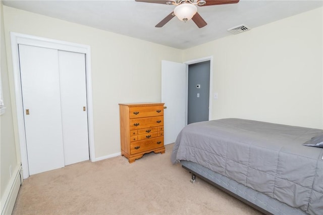 bedroom featuring a ceiling fan, visible vents, a closet, and light colored carpet