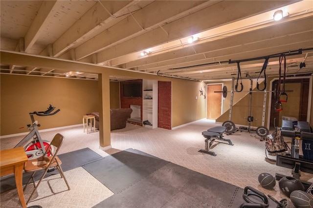 workout area with baseboards and carpet flooring