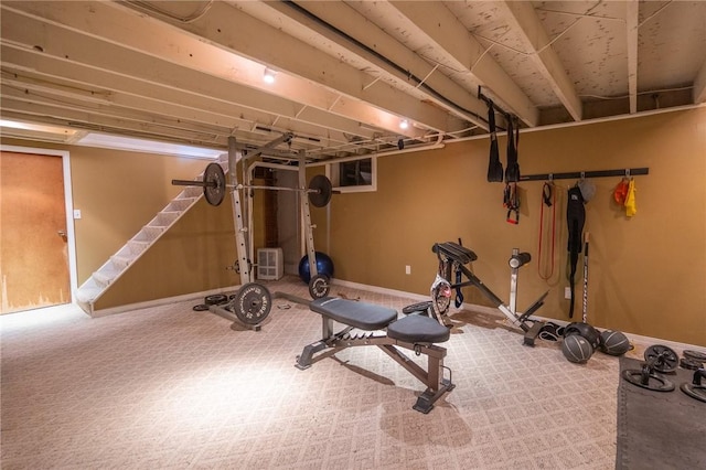 exercise room featuring carpet floors and baseboards