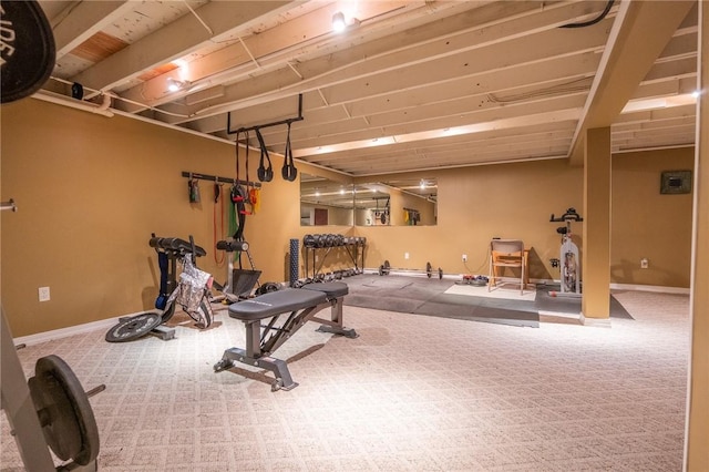 exercise area featuring carpet and baseboards