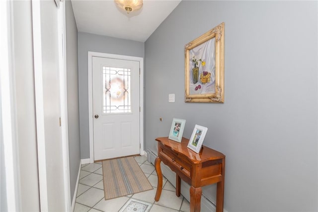 foyer entrance with light tile patterned flooring and baseboards