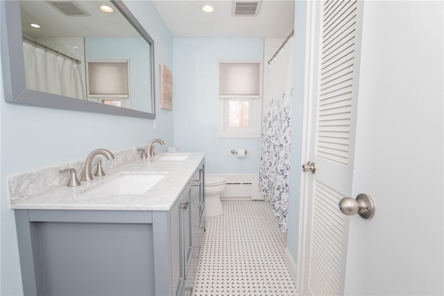 bathroom with toilet, a baseboard radiator, a sink, and visible vents