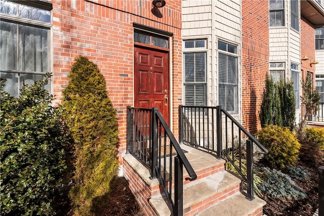 doorway to property with brick siding