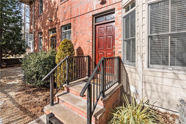 view of exterior entry with brick siding