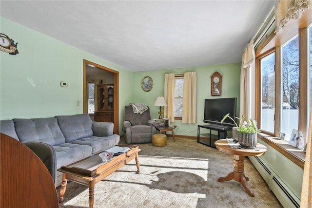 living area featuring carpet, baseboards, and baseboard heating