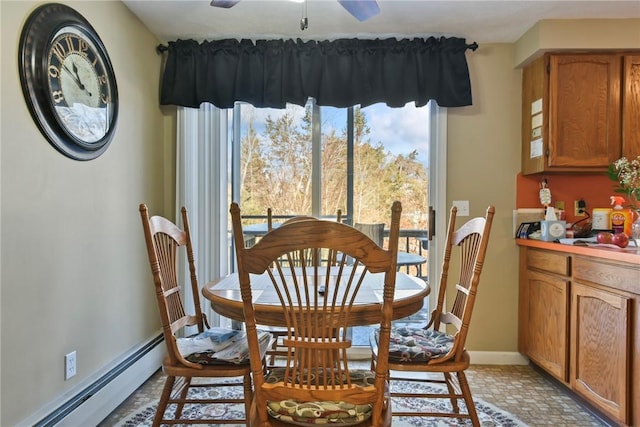 dining area with a baseboard heating unit, brick floor, a ceiling fan, and baseboards