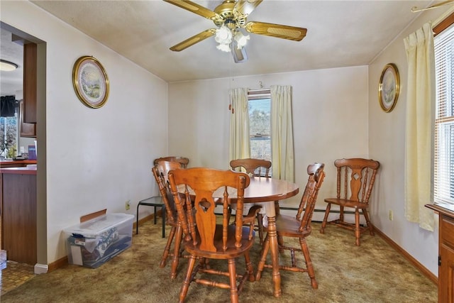 carpeted dining space featuring a baseboard radiator, baseboards, and ceiling fan