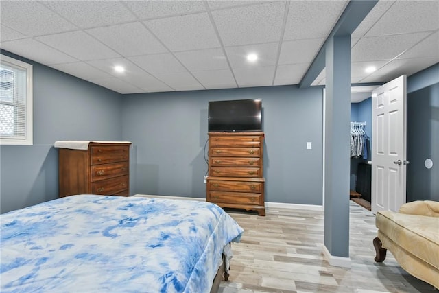 bedroom featuring recessed lighting, a closet, a spacious closet, wood finished floors, and baseboards