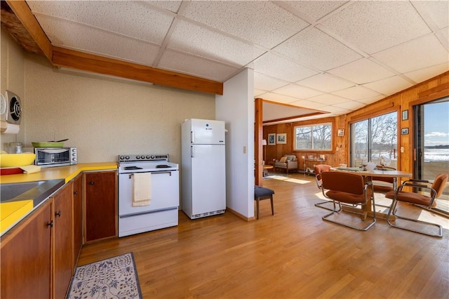 kitchen featuring white appliances, light wood-style flooring, a toaster, and a drop ceiling