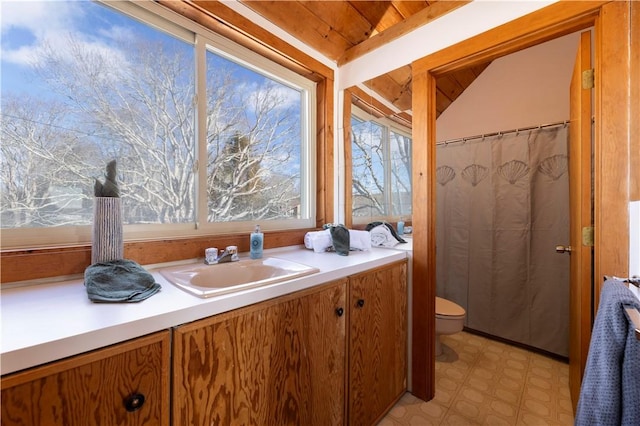 full bathroom featuring lofted ceiling, toilet, wood ceiling, vanity, and tile patterned floors