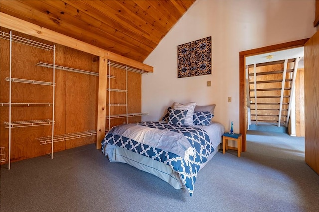 carpeted bedroom with high vaulted ceiling and wood ceiling