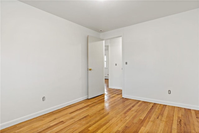 spare room with light wood-style flooring, baseboards, and baseboard heating