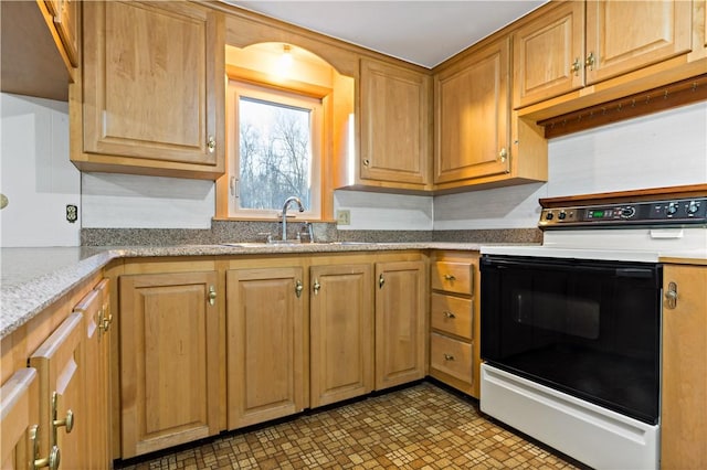 kitchen featuring a sink, light stone counters, and electric range oven