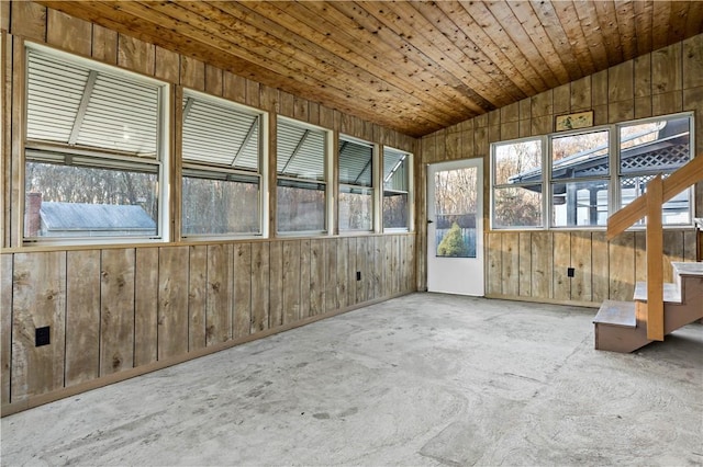 unfurnished sunroom featuring vaulted ceiling and wooden ceiling