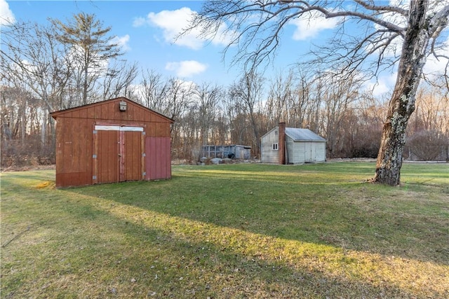 view of yard featuring a shed and an outbuilding