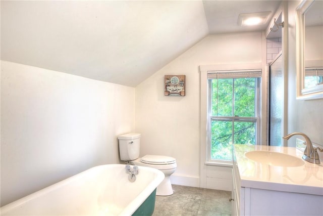 full bathroom featuring a freestanding tub, toilet, plenty of natural light, lofted ceiling, and vanity