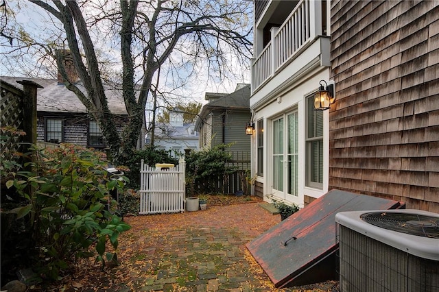 view of yard with fence and central AC