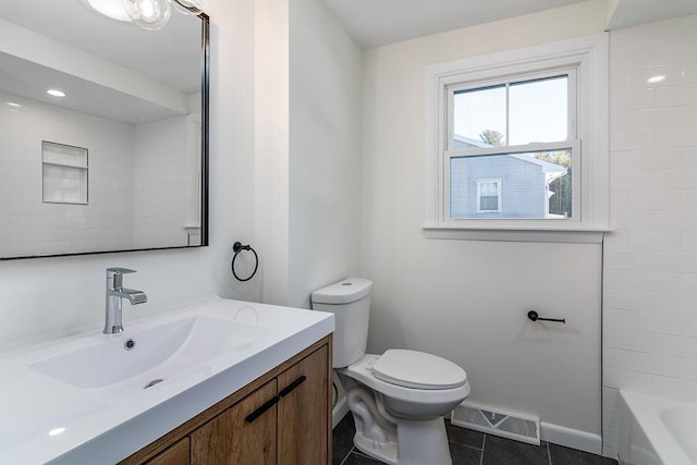 bathroom with visible vents, toilet, vanity, tile patterned flooring, and baseboards