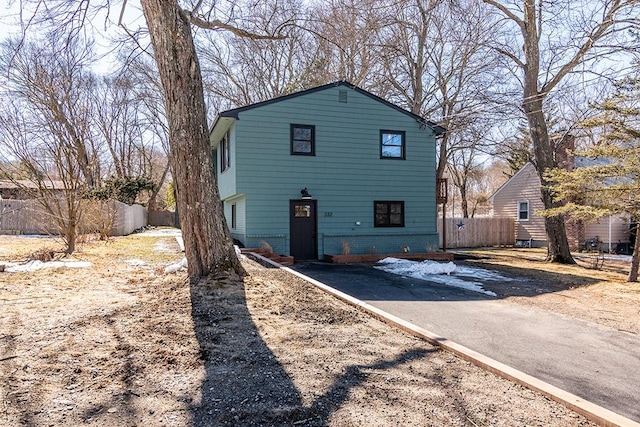 view of front of house with brick siding and fence