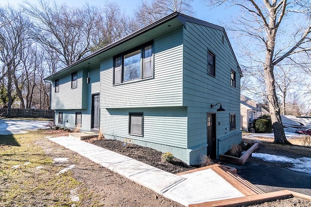 view of home's exterior with fence