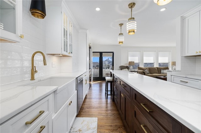 kitchen featuring plenty of natural light, white cabinets, dark brown cabinets, and stainless steel dishwasher