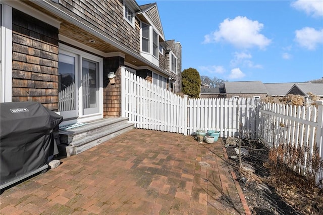 view of patio featuring fence and grilling area