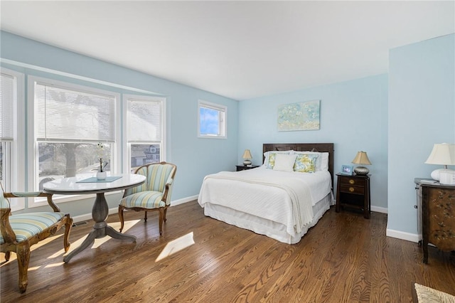 bedroom featuring baseboards and wood finished floors