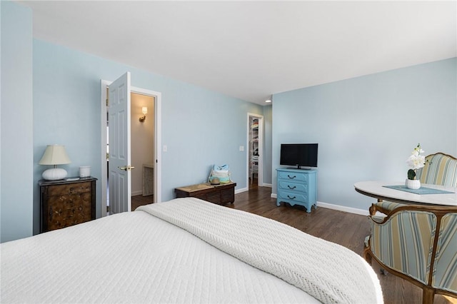 bedroom featuring wood finished floors and baseboards