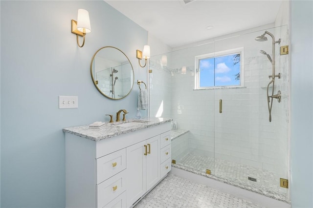 bathroom with a shower stall and vanity