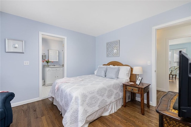 bedroom featuring baseboards and wood finished floors