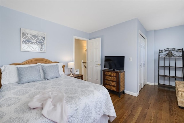 bedroom featuring a closet, baseboards, and dark wood-type flooring