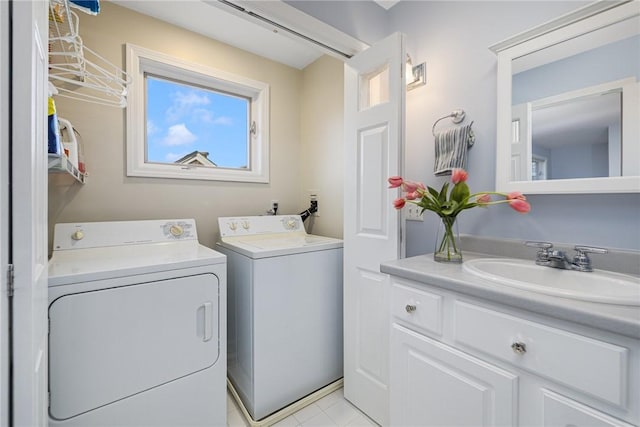 clothes washing area with laundry area, washer and dryer, and a sink