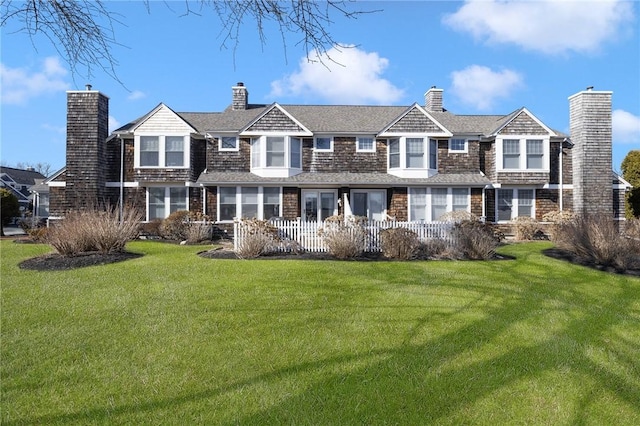 view of front of home with a front lawn and a chimney