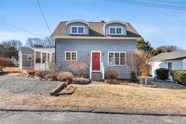 view of front of house featuring a shingled roof and a pergola