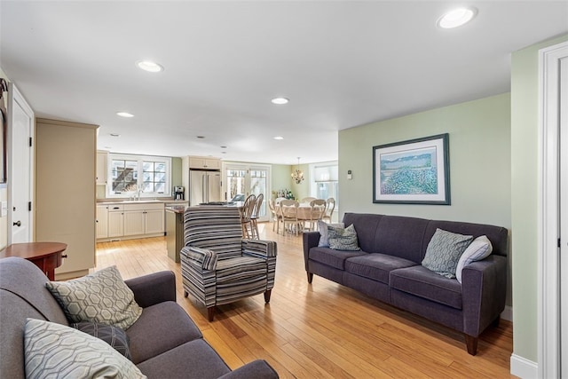 living room featuring light wood-style flooring and recessed lighting