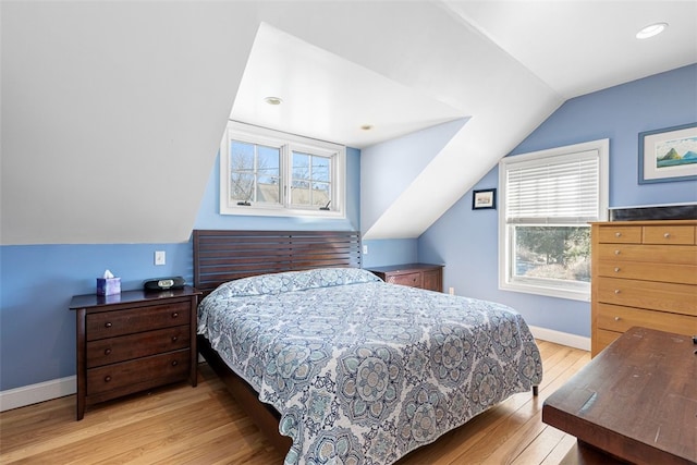 bedroom with lofted ceiling, hardwood / wood-style flooring, baseboards, and recessed lighting