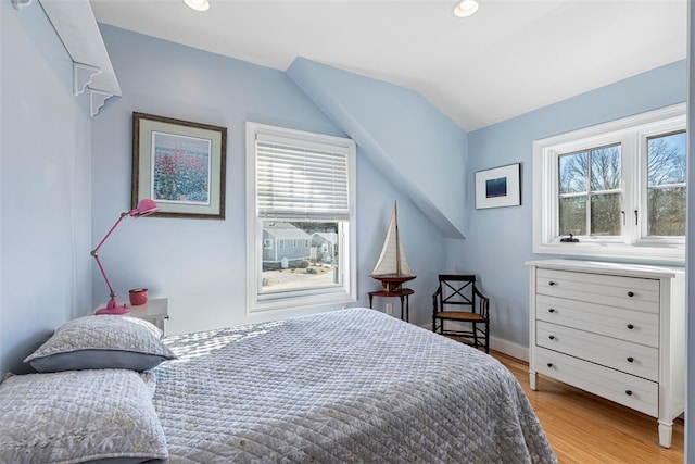 bedroom featuring light wood-style floors, baseboards, vaulted ceiling, and recessed lighting