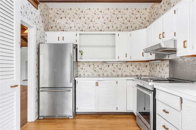 kitchen with open shelves, light countertops, appliances with stainless steel finishes, under cabinet range hood, and wallpapered walls