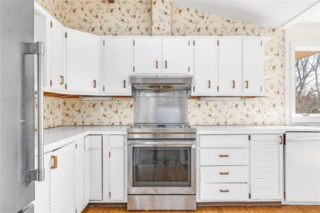 kitchen featuring under cabinet range hood, white dishwasher, light countertops, and wallpapered walls