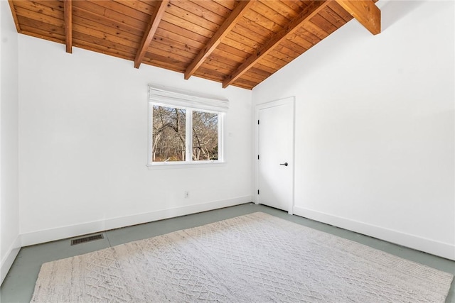 unfurnished room featuring visible vents, vaulted ceiling with beams, finished concrete flooring, and baseboards