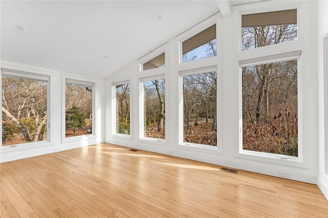 unfurnished sunroom with visible vents and vaulted ceiling