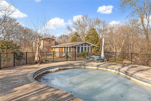 view of swimming pool with a patio area and fence