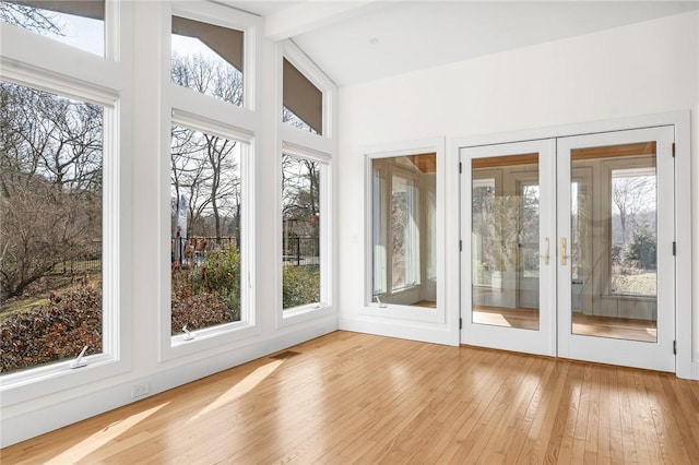 unfurnished sunroom with vaulted ceiling with beams, visible vents, and french doors