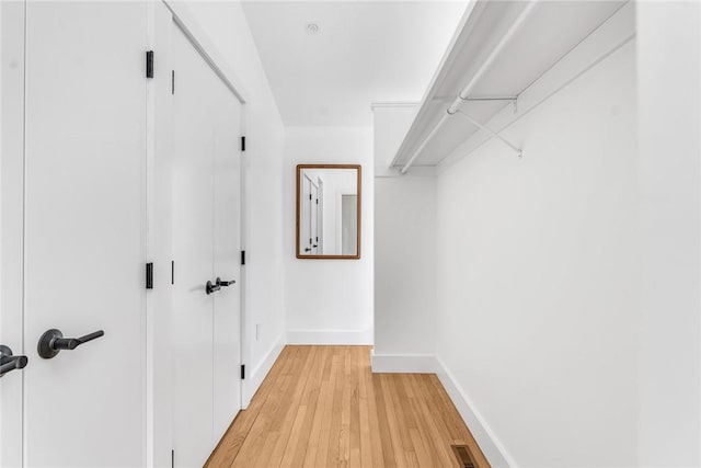 walk in closet featuring light wood finished floors and visible vents