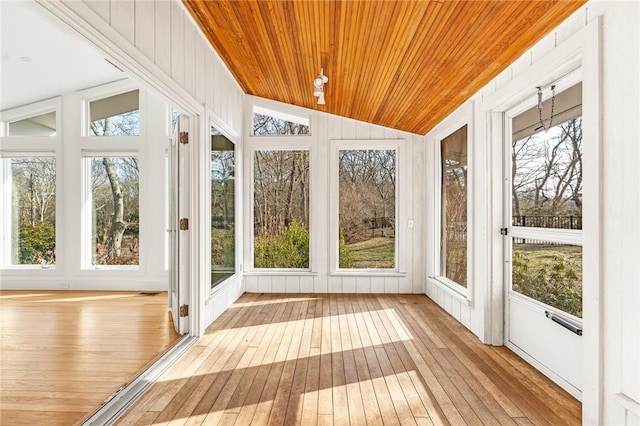 unfurnished sunroom featuring lofted ceiling and wooden ceiling