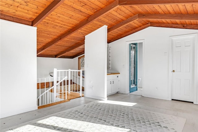 additional living space with wooden ceiling, vaulted ceiling with beams, and baseboards